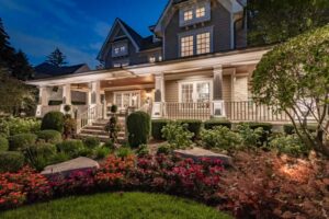 Elegantly illuminated home at night, featuring professionally designed outdoor lighting that enhances the architecture and landscaping, ideal for promoting an outdoor lighting franchise.